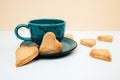 A cup of coffee with a plate with heart-shaped shortbread cookies on a white background Royalty Free Stock Photo