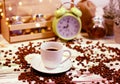 A cup of coffee on a platter with lots of sprinkled coffee beans. Alarm clock arrows at 9 am. Wooden textured table