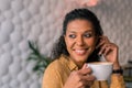 Portrait of beautiful dark-haired curly woman enjoying her cup of coffee Royalty Free Stock Photo
