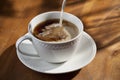 Cup of Coffee and Pouring Creamer Royalty Free Stock Photo