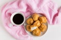 A cup of coffee with profiteroles. White background. Morning coffee. Tender composition with coffee. A cup of coffee on a table