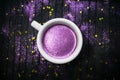 Cup of coffee with purple glitter on dark background with golden Royalty Free Stock Photo