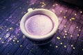 Cup of coffee with purple glitter on dark background with golden Royalty Free Stock Photo