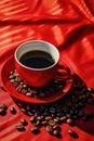 A cup of coffee on a red tray with several coffee beans spilling out Royalty Free Stock Photo