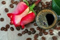 Cup of coffee, roasted coffee beans and red rose on a wooden table. romantic coffee. close up