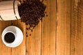 Cup of coffee, roasted coffee beans on wooden background, coffee wooden barrel top view, copy space for text, close up coffee Royalty Free Stock Photo