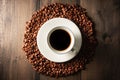 Cup of coffee on the roasted coffee beans on the wooden table. Shot from above. Warm colors background with coffee beans Royalty Free Stock Photo