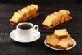 Cup of coffee, rusks on wooden table Royalty Free Stock Photo