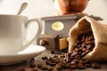 Cup coffee sack and grinder on wooden table detail front Royalty Free Stock Photo