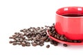 A cup of coffee and scattered coffee beans on white background