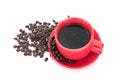 A cup of coffee and scattered coffee beans on white background