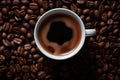 a cup of coffee is sitting on top of a pile of coffee beans Royalty Free Stock Photo