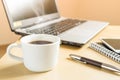 Cup of coffee, smartphone and laptop on the desk