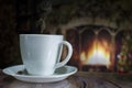 Cup of coffee with smoke on the background of the Christmas fireplace Royalty Free Stock Photo