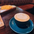 Cup of coffee with snack and blue servings