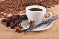 Cup with coffee and spices on burlap Royalty Free Stock Photo