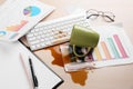 Cup of coffee spilled over computer keyboard on wooden office desk Royalty Free Stock Photo