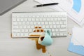 Cup of coffee spilled over computer keyboard on white office desk, flat lay Royalty Free Stock Photo