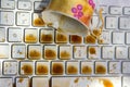 Cup of coffee spilling onto a laptop keyboard Royalty Free Stock Photo