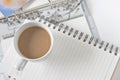 A cup of coffee on spiral notebook Royalty Free Stock Photo