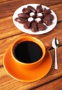 Cup of coffee with spoon and chocolate candies Royalty Free Stock Photo