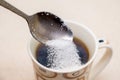 Cup of coffee and spoonful of sugar, sugar is poured into coff Royalty Free Stock Photo