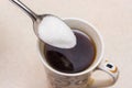 Cup of coffee and spoonful of sugar, sugar is poured into coff Royalty Free Stock Photo