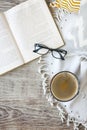 Cup of coffee staying by the book and glases on the wooden table