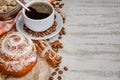 Cup of coffee with steam, coffee beans, chocolate pieces, cinnamon sticks, white and brown sugar, and scoop on burlap background. Royalty Free Stock Photo