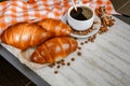 Cup of coffee with steam, coffee beans, chocolate pieces, cinnamon sticks, white and brown sugar, and scoop on burlap background. Royalty Free Stock Photo