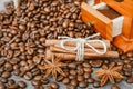 Cup of coffee with steam, coffee beans, chocolate pieces, cinnamon sticks, white and brown sugar, and scoop on burlap background. Royalty Free Stock Photo