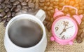 Cup of coffee with steam and pink clock Royalty Free Stock Photo