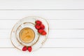 Cup of coffee and strawberries on white wooden table. Top view Royalty Free Stock Photo