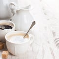 Cup of coffee with sugar cubs and milk jug Royalty Free Stock Photo