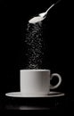 A cup of coffee with sugar flow and spoon Royalty Free Stock Photo