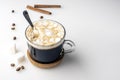 Cup of coffee, suger cubes, coffee beans, marshmallows and cinnamon sticks Royalty Free Stock Photo