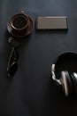 cup of coffee, sun glasses, smartphone, headphones on a black background Royalty Free Stock Photo