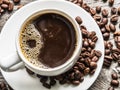 Cup of coffee surrounded by coffee beans. Top view. Royalty Free Stock Photo