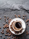 Cup of coffee surrounded by coffee beans. Top view.