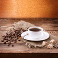 Cup of coffee, sweets and roasted beans. Coffee concept. Selective focus. Royalty Free Stock Photo