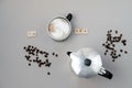 Cup of coffee switching on, grains and coffee pot on grey background. Top view, flat lay Royalty Free Stock Photo