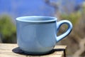 A cup of coffee on the table on blue beach outdoor background. Top view. Morning coffee concept. Royalty Free Stock Photo