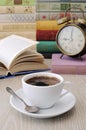 A cup of coffee on a table among books Royalty Free Stock Photo