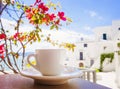 A cup of coffee on table with Italian town at the background