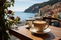 A cup of coffee on a table of outdoor restaurant in small seaside town in Italy. Having breakfast coffee in Italian scenery on Royalty Free Stock Photo