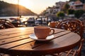 A cup of coffee on a table of outdoor restaurant in small seaside town in Italy. Having breakfast coffee in Italian scenery on Royalty Free Stock Photo