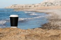 Cup of coffee on a table over blue sky and empty sea beachside. Summer holiday concept. Mock up, copy space Royalty Free Stock Photo