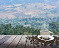 Cup with coffee on table over mountains Royalty Free Stock Photo