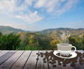 Cup with coffee on table over mountains Royalty Free Stock Photo