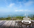 Cup with coffee on table over mountains Royalty Free Stock Photo